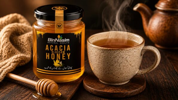 Jar of Bin Nasim Acacia Blossom Honey beside a steaming cup of tea on a dark wooden table, illustrating a natural home remedy for cough relief